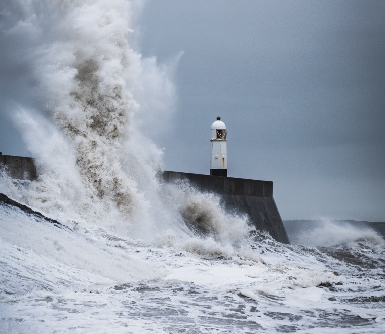 A wave overtopping the Porthcawl breakwater