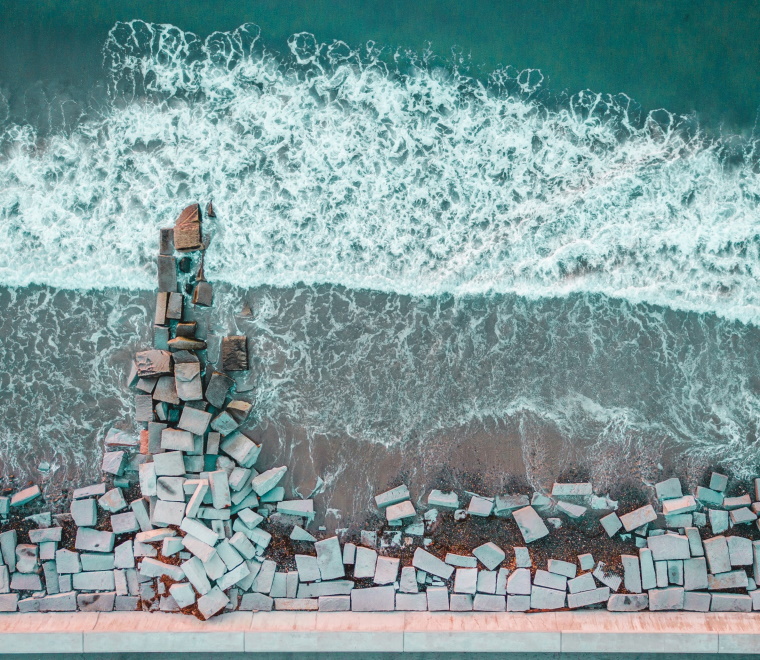 A birds-eye view of bricks laid out on a beach 